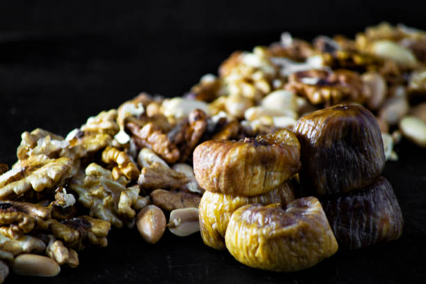 istock dried figs and dried fruit with peanuts and walnuts 1200333161