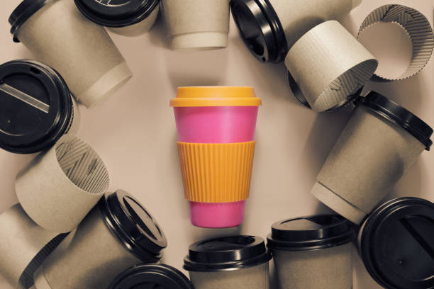 istock Zero waste concept Stylish reusable eco coffee cup vs multiple single use cardboard cups. Ban single use plastic. 1200335580