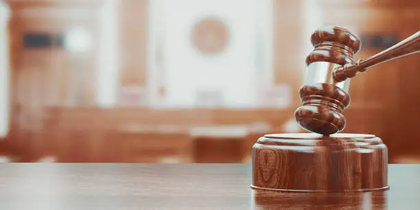 Photo of Wooden gavel on table close up. 3d rendering