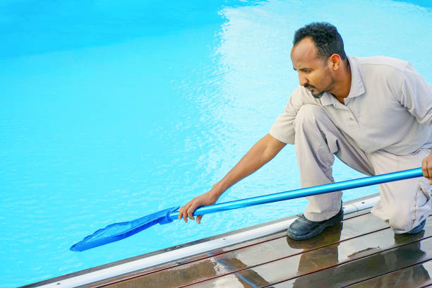 istock African Hotel staff worker cleaning the pool 1200335676