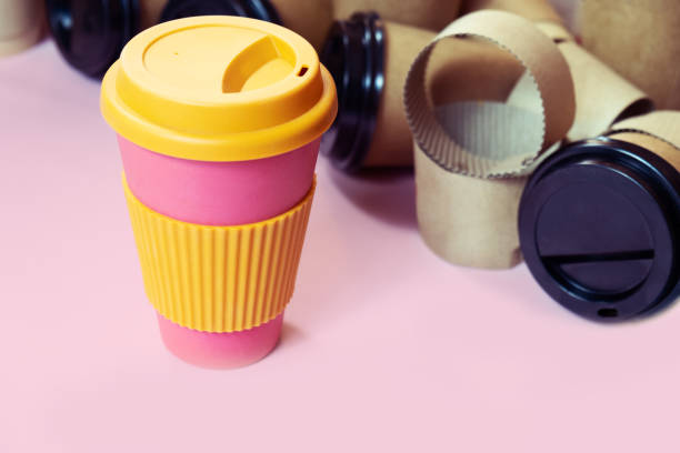 istock Zero waste concept Stylish reusable eco coffee cup vs multiple single use cardboard cups. Ban single use plastic. 1200335725