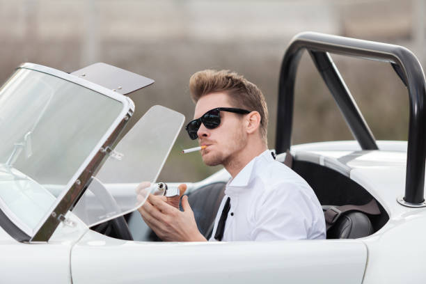 happy bride and groom near the retro car - haute couture beautiful smoking beauty imagens e fotografias de stock