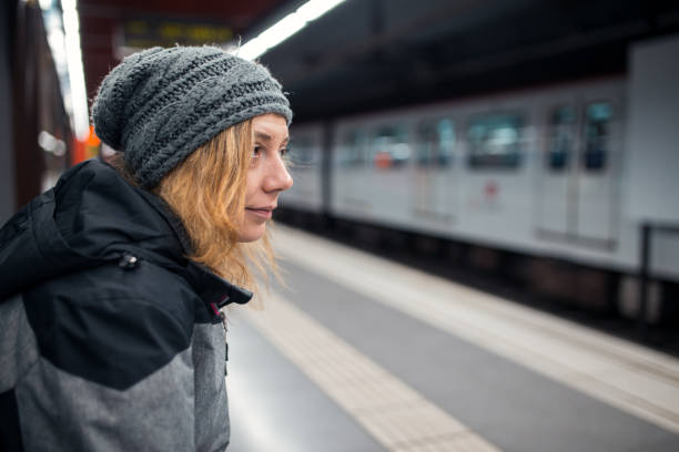 istock Woman waiting for train at subway station 1200337207
