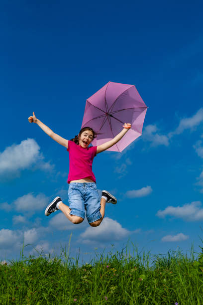 istock Girl jumping outdoor 1200337364
