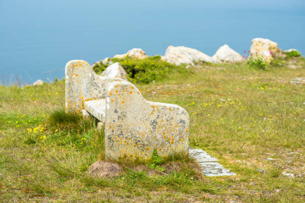 A stone clad bench against a block wall
