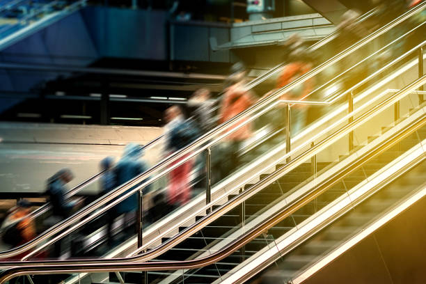 People on escalator inside  train station , travel concept blur