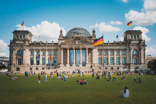 Many people on meadow in front of the Reichstag building (German Bundestag), a famous  landmark on a sunny, summer day Berlin, Germany - August, 2019: Many people on meadow in front of the Reichstag building (German Bundestag), a famous  landmark on a sunny, summer day in Berlin, Germany bundestag photos stock pictures, royalty-free photos & images