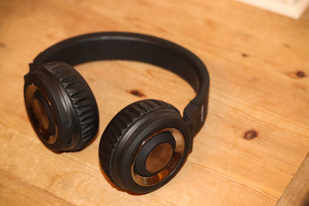 istock Black stereo headphones on a table 1200345862