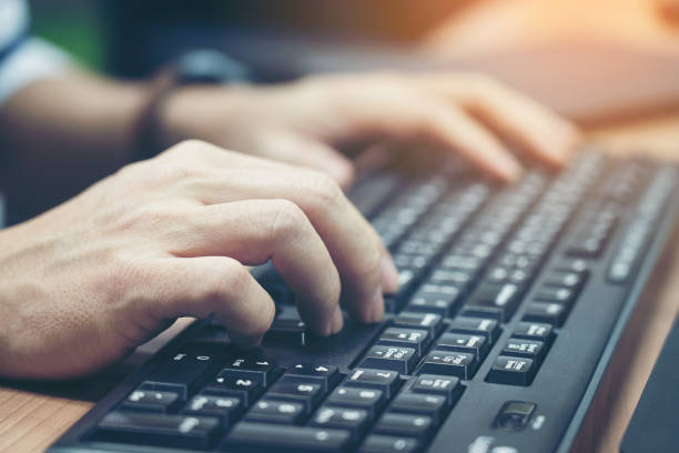 istock Close-up of typing male hands on keyboard. 1200346245