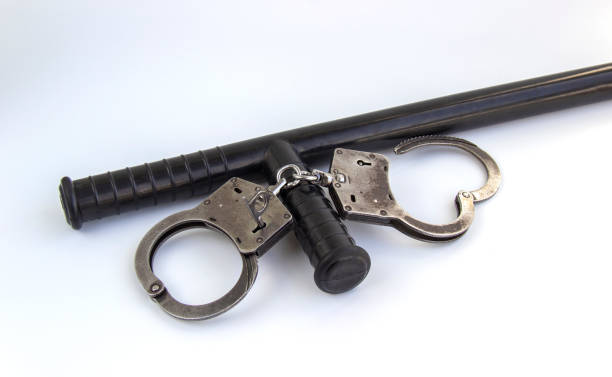 istock real police handcuffs and baton isolated on white background 1200348680