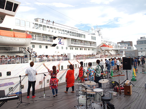 Yokohama, Japan - August 16th, 2018: People celebrating the departure of cruise ship Pacific Venus at the Osanbashi Pier in Yokohama.