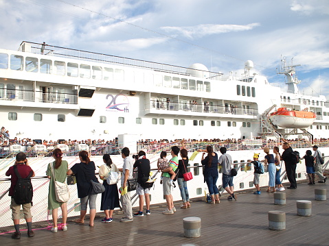 Yokohama, Japan - August 16th, 2018: People celebrating the departure of cruise ship Pacific Venus at the Osanbashi Pier in Yokohama.