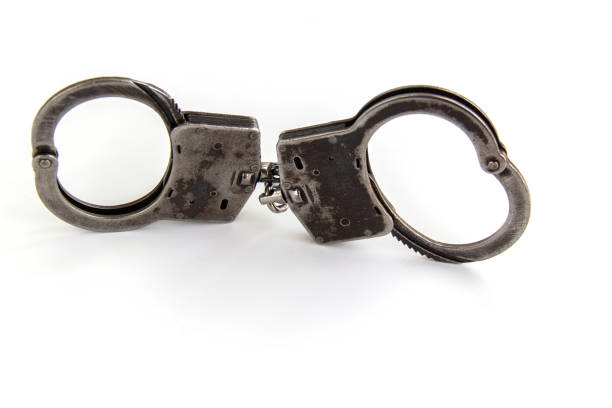 istock real police handcuffs isolated on white background 1200348888