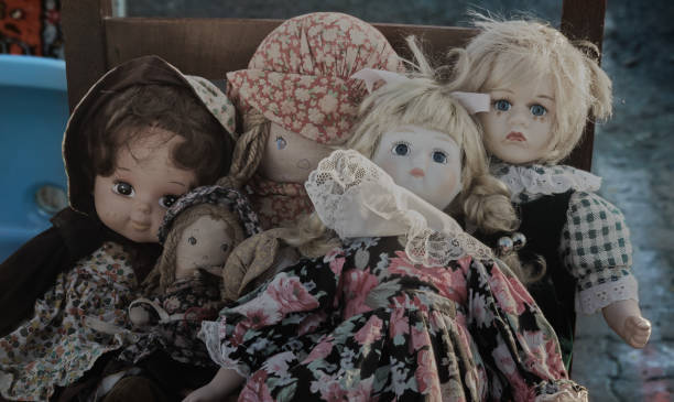 istock Group of sad dolls in old fashioned clothes 1200349215