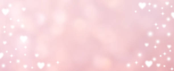 istock abstract blur beautiful pink color gradient and shine flash glowing in panoramic background with illustration white heart shape light and twinkle for valentines day 14 february season of love concept 1200349289