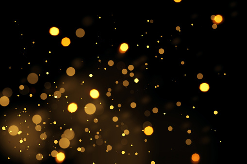 Photography of an abstract holiday / party  background. Golden shiny glitter, lens flares, and defocused lights. Native image size: 7952x5304