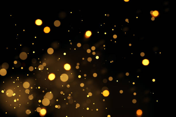 Defocused lights background Golden defocused lights, sparkles, bokeh over black background bokeh light stock pictures, royalty-free photos & images