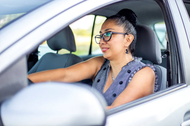 istock Latina woman driving 1200355161