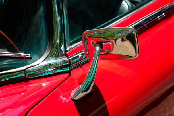 istock rear mirror, car mirror closeup on red oldtimer car - 1200355344