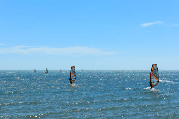 Surfer at beach - group of windsurfer on ocean Surfer at beach - group of windsurfer on ocean mui ne bay photos stock pictures, royalty-free photos & images