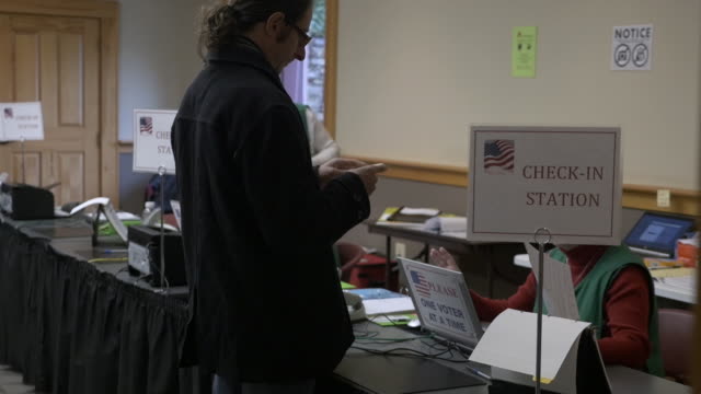 Male voter checking in at a voting location during an election