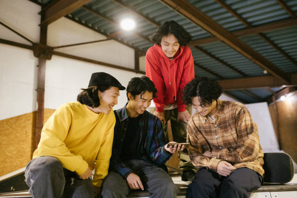 istock Friends watching skateboarding videos. 1200356338