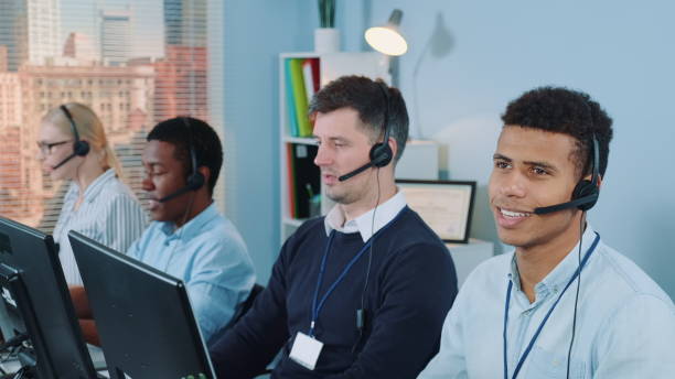istock Cheerful customer support agent of mixed ethnicity talking on phone with a headset 1200357712