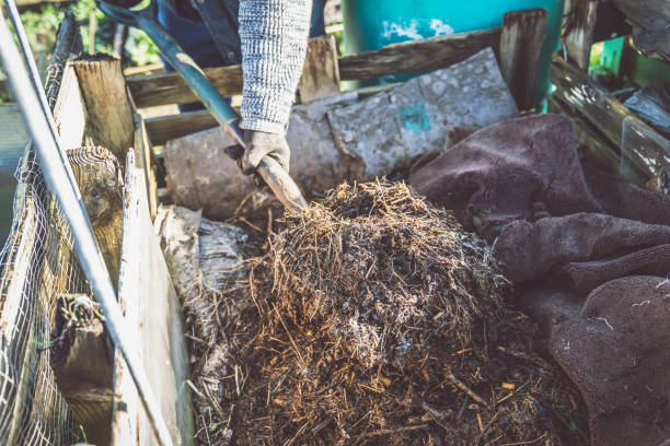 istock A Gardener digs into a large heap of compost 1200359126