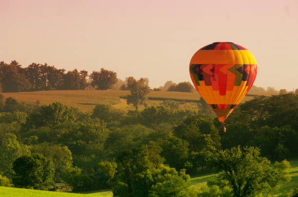 istock Hot Air Balloon Above Rural Landscape 1200359712