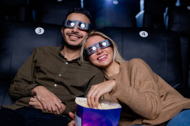 istock Happy young affectionate dates in 3d eyeglasses enjoying movie on large screen 1200360810