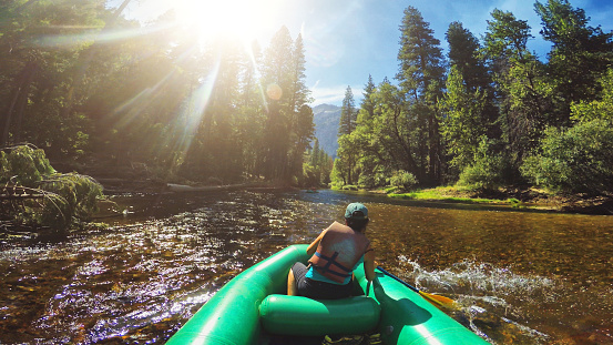 POV of a woman rafting in Merced River of Yosemite