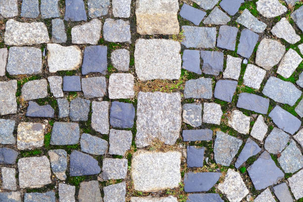 Texture of old Cobbled Pavement close-up. Abstract Granite Stone Background.\