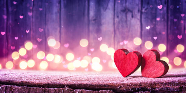 Two Red Hearts On Rustic Table With Soft Lights stock photo