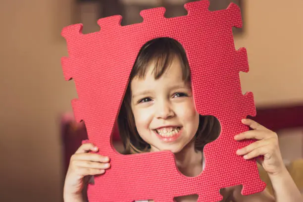 Photo of Cute little girl is playing at home.