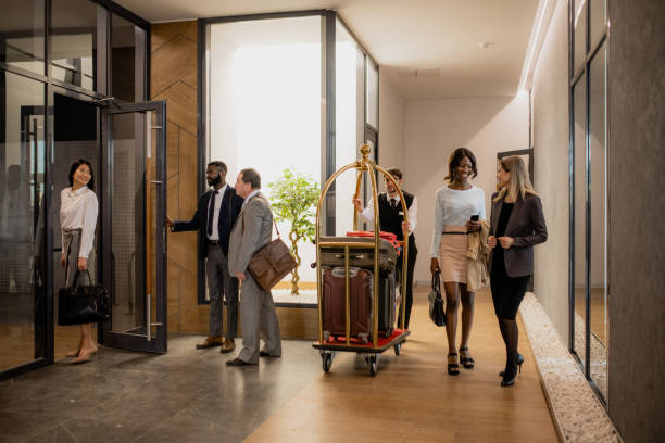 istock Contemporary business people communicating while porter moving among them 1200367233