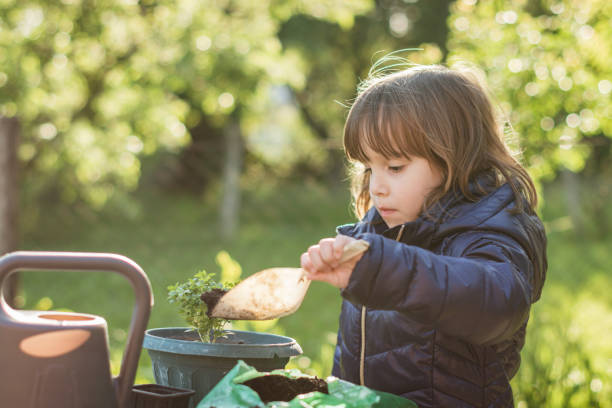 istock A little girl planted flowers. 1200367629