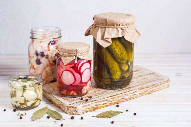 istock Fermented vegetables, pickled, cabbage, cucumbers, radish and garlic in a glass jaron on a light background with copy space. Horizontal orientation 1200368927