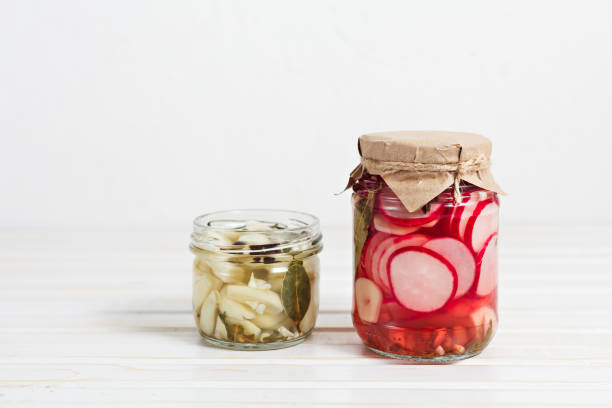 istock pickled radish and garlic in a glass jaron on a light background with copy space. Fermented vegetables It's healthy and delicious 1200368945