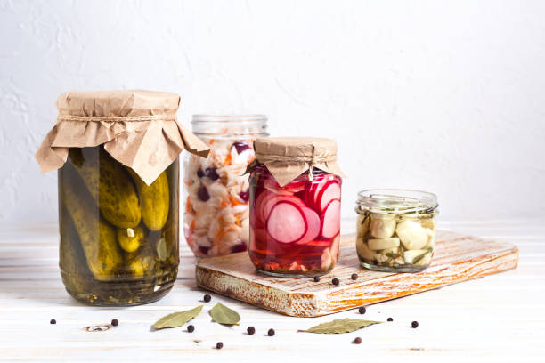 istock Fermented vegetables, pickled, cabbage, cucumbers, radish and garlic in a glass jaron on a light background with copy space. Horizontal orientation 1200368981