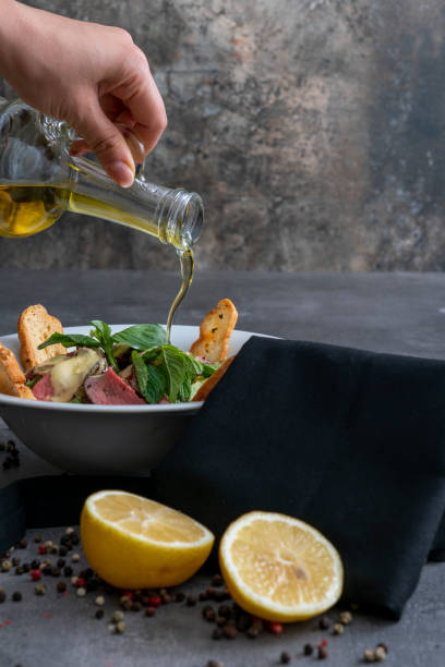 istock Seasoning oil to salad 1200370526