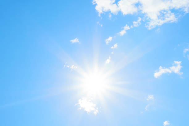 istock Bright sun with beautiful beams in the sky with clouds 1200374027