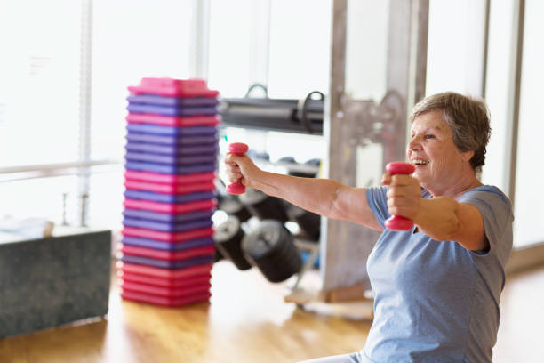 istock octogenarian senior woman exercising in gym 1200375242