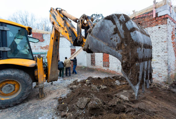 istock The modern excavator performs excavation work on the construction site. Front view of a digger bucket of digging ground as a part of industry machinery. 1200376426