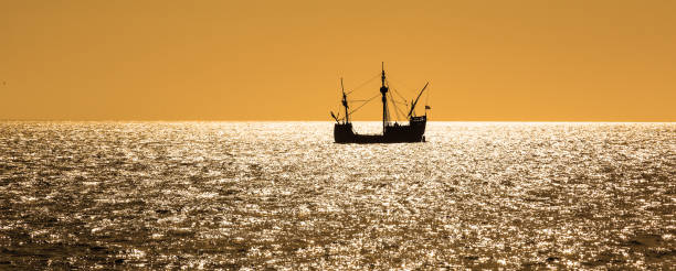 silhouette view of the Santa Maria tallship of Columbus silhouette view of the Santa Maria tallship of Columbus, sailing the Atlantic ocean around Madeira island in summer at sunset funchal christmas stock pictures, royalty-free photos & images