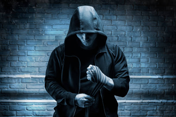 istock Young boxer preparing for fight, wrapping hands with bandage, copy space. 1200379905