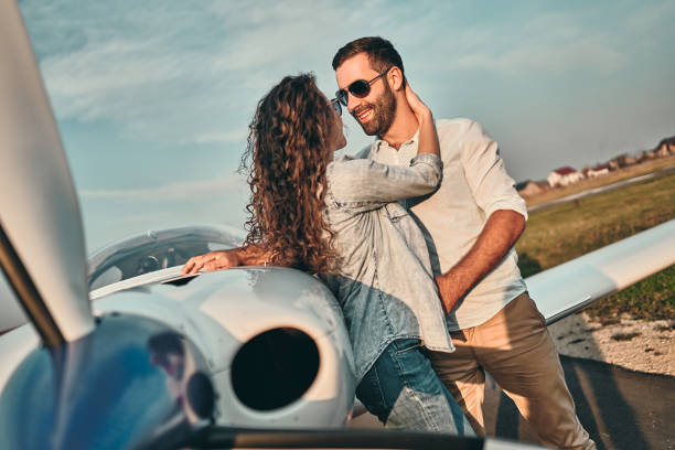 istock Couple in love hugging near private plane 1200382229
