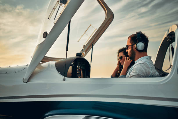 istock Two people sit into ultralight propeller-driven airplane and get ready for taking off 1200382240