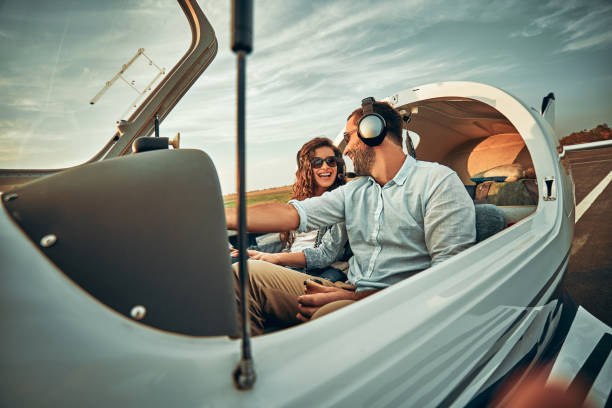 Couple in love in a small private airplane Couple in love in a small private airplane. Boyfriend is training his girlfriend vehicle interior audio stock pictures, royalty-free photos & images