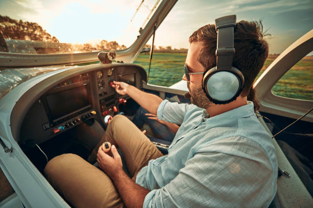 istock Stylish man pilot in a small plane prepare take off 1200383625