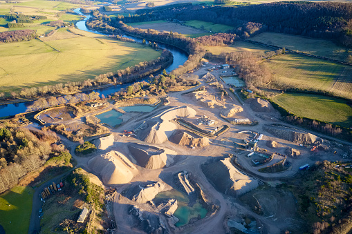 Quarry works industrial digging aerial view from above showing sand mound and hills uk